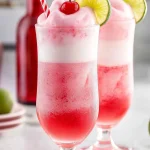 Delicious Shirley Temple Ice Cream Float with cherry and sprinkles