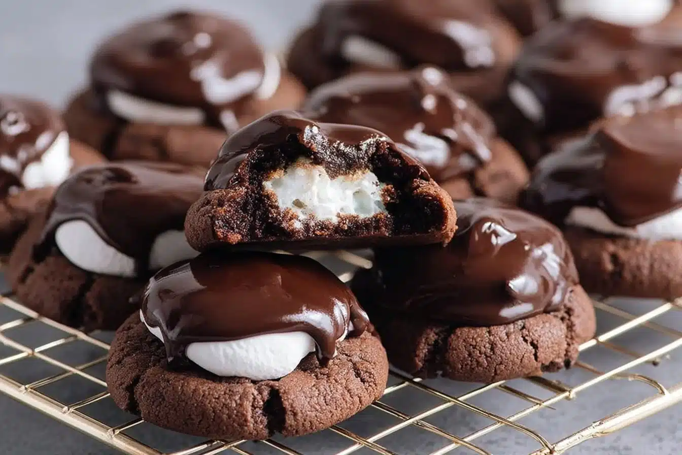 Delicious chocolate covered marshmallow cookies on a plate.