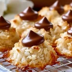 Delicious Coconut Macaroon Blossoms stacked on a plate.