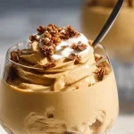 Delicious homemade peanut butter mousse in a dessert bowl garnished with chocolate.