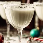 Frosty Snowflake Martini cocktail garnished with snowflake design.