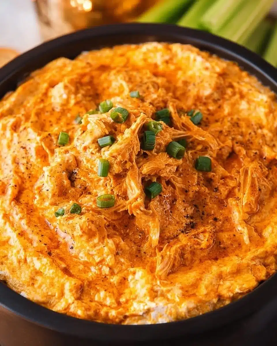 Slow Cooker Buffalo Chicken Dip in a serving dish with crispy tortilla chips