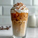 Delicious creamy vanilla iced coffee served in a glass with ice