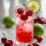 Vintage Cherry Limeade in a glass with lime and cherries garnish