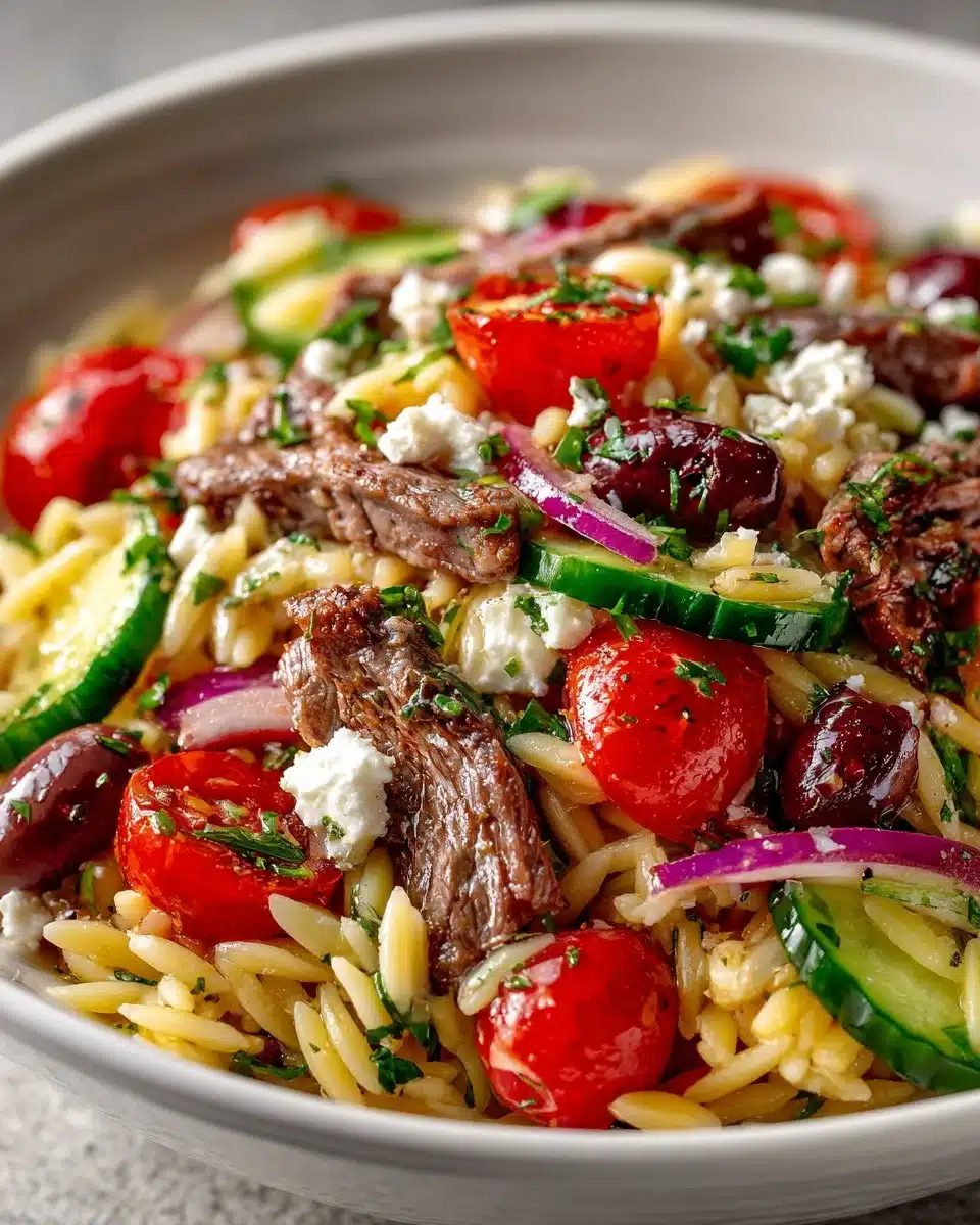 Mediterranean beef and orzo salad served in a bowl with fresh ingredients