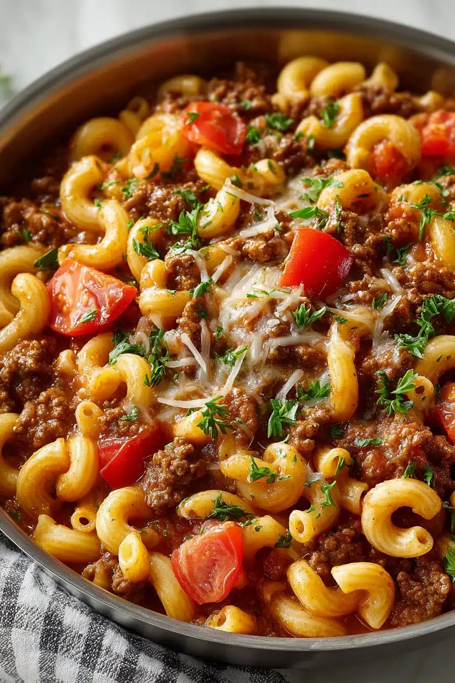 Classic beef goulash recipe in a skillet with fresh ingredients